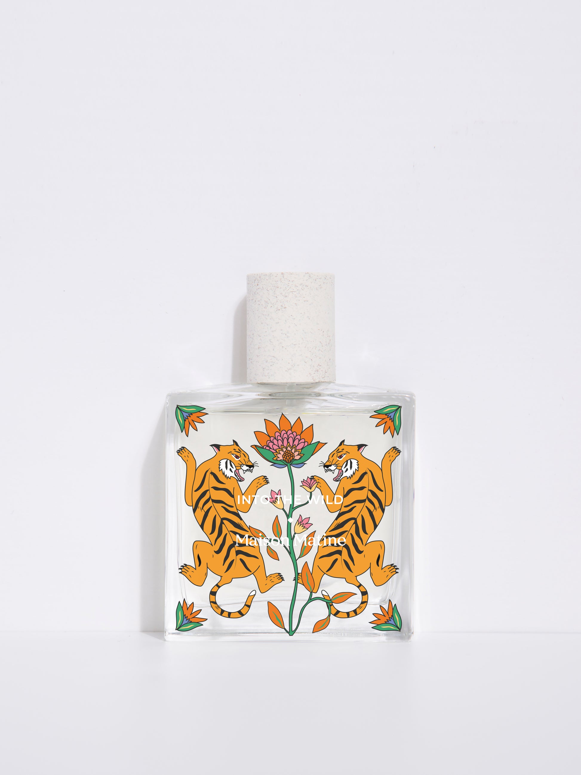into the wild de Maison Matine, perfume nicho con ilustracion de tigres y flores en el bote cuadrado