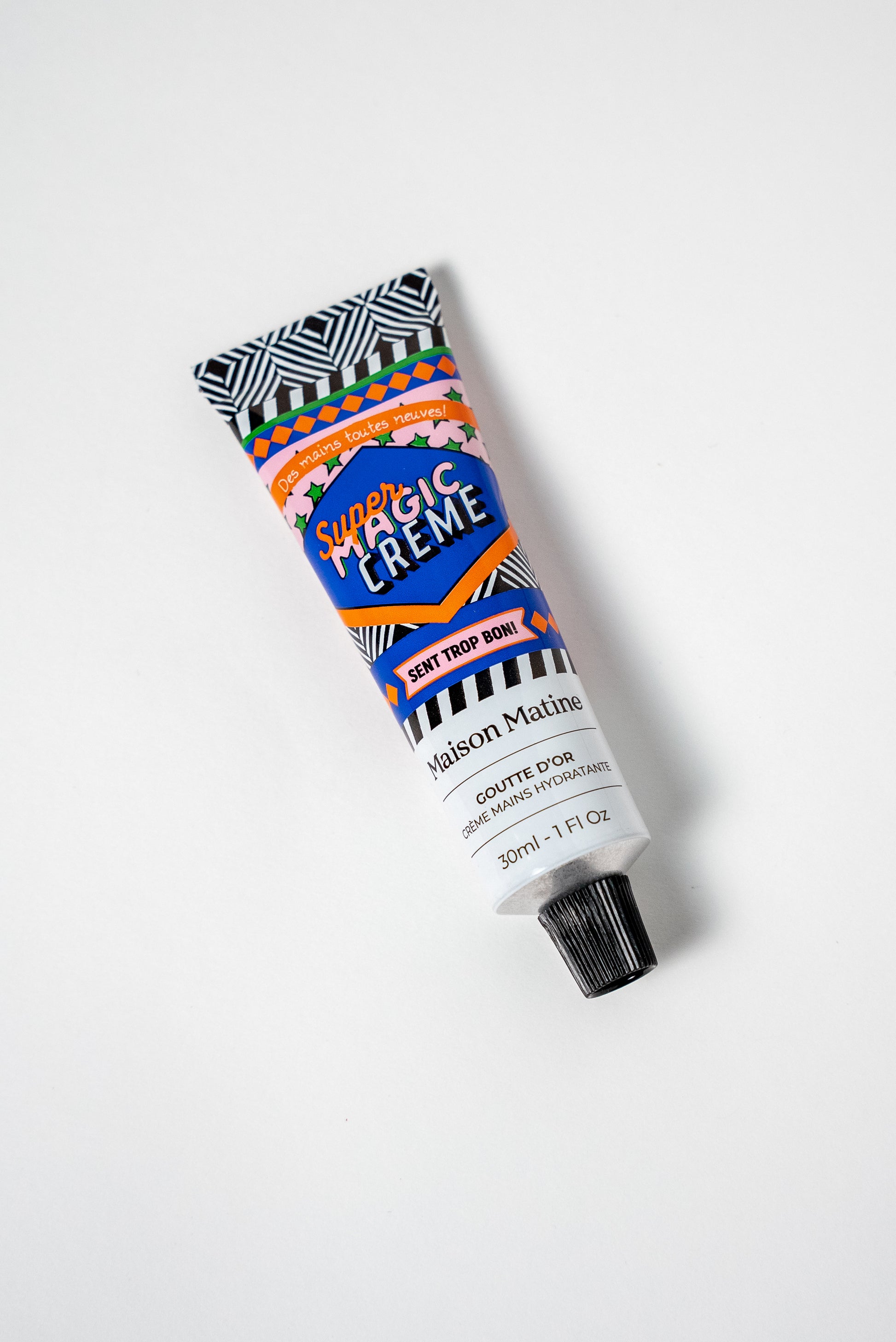 GOUTTE D'OR hand cream de Maison Matine con bote de colores azul, rosa, blanco y negro