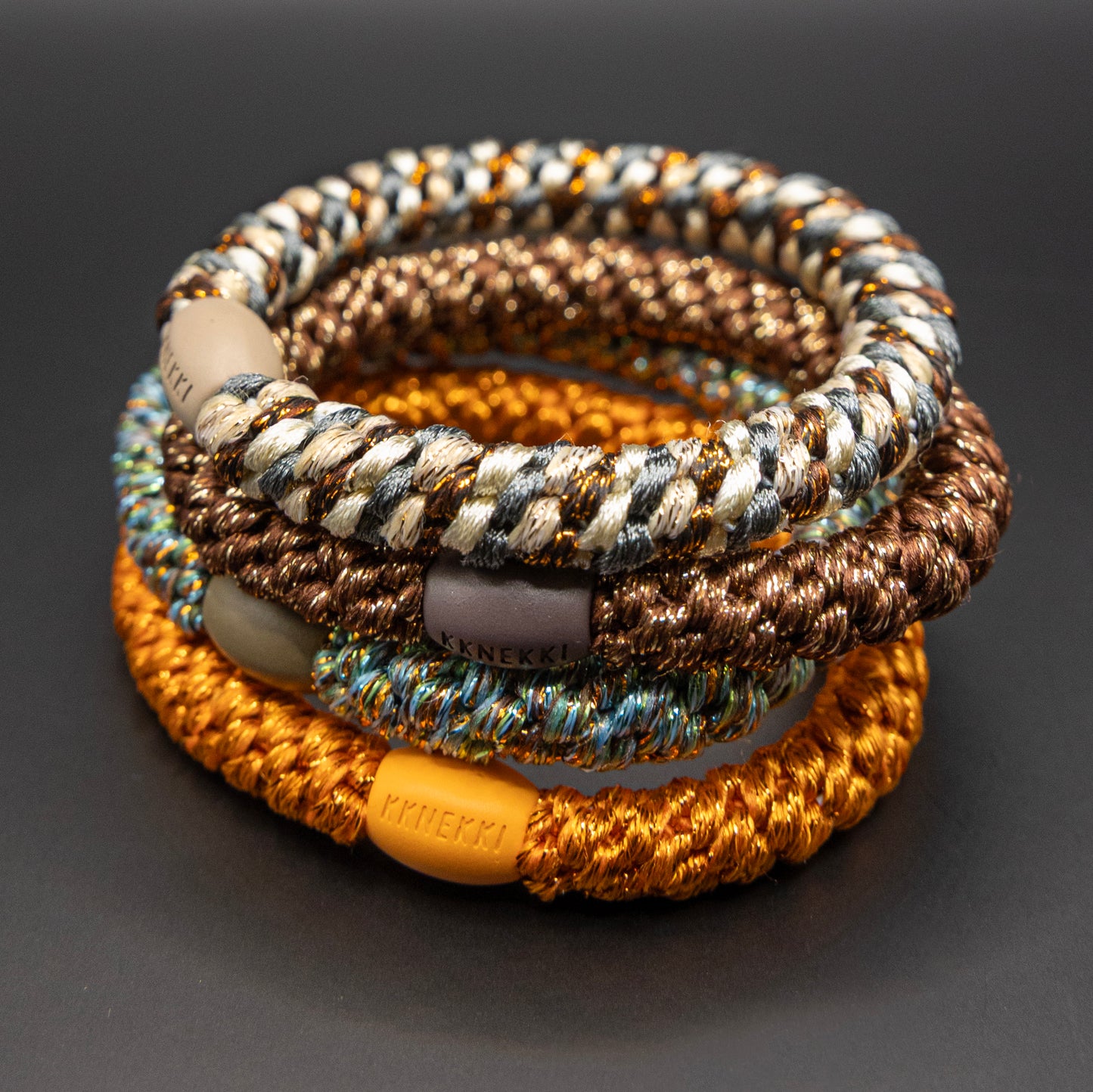 kknekki gomas elasticas color bronze y naranja vendidos en pack de cuatro