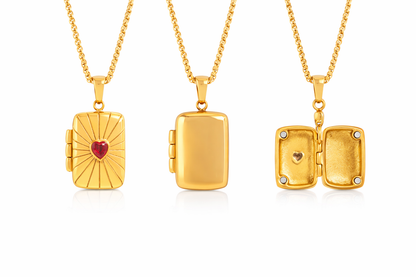 Three gold lockets with heart designs on a white background