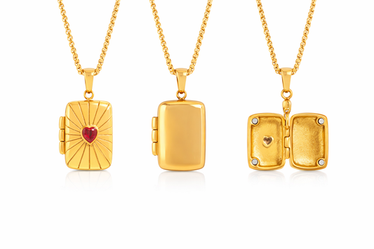 Three gold lockets with heart designs on a white background