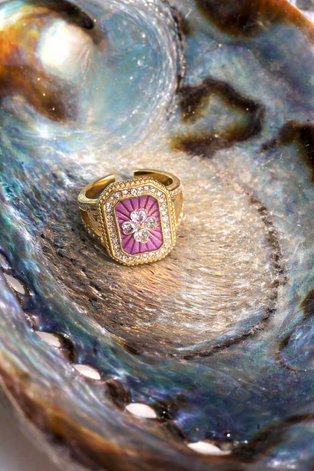 Gold ring with a pink clover design with white crystals by ortigas rosas