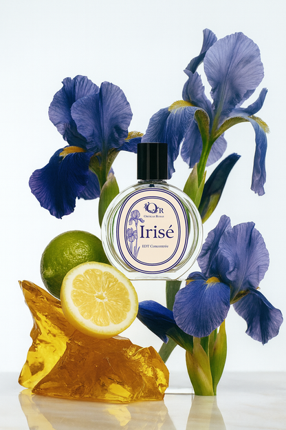 frasco de perfume irisé con etiqueta ovalada y ilustracion de iris en estilo vintage y con marcos ovalados en color morado con un fondo de iris y limon 
