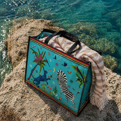 Colorful bag with zebra design on a rock by the water