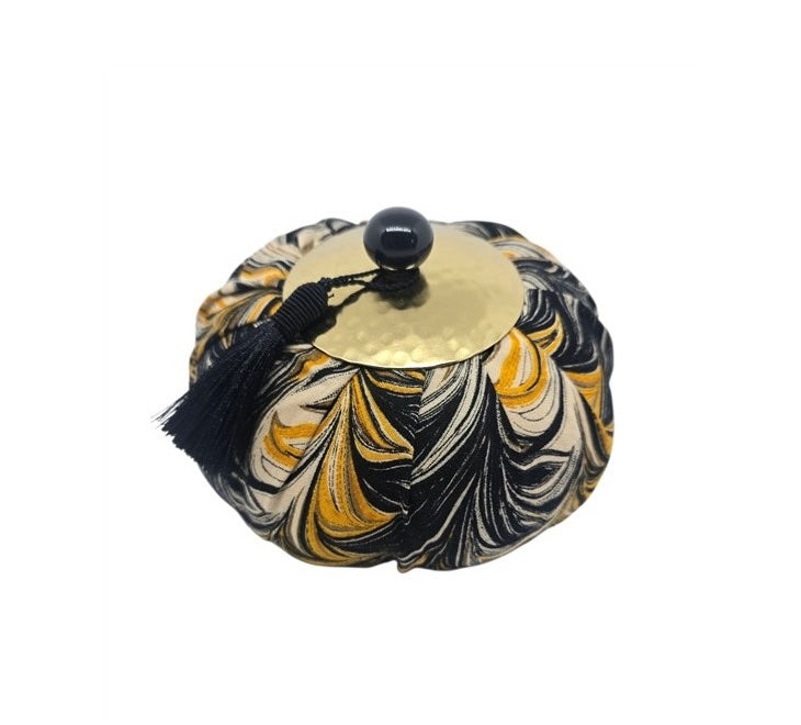 Decorative cymbal with marbled pattern on a white background